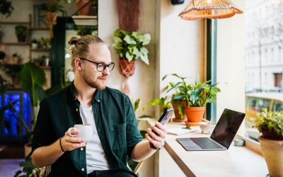 Student Using Smartphone While Drinking Coffee Student Using Smartphone While Drinking Coffee